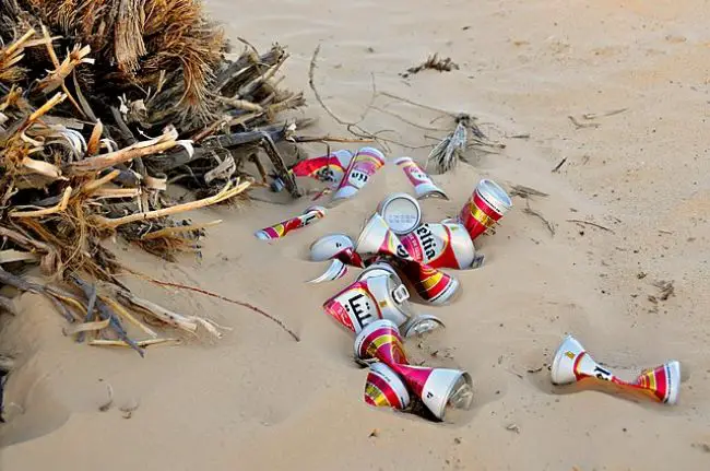 Empty Beer Cans Littering The Beach.