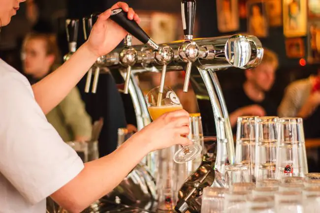 A Bartender Serving Tap Beer.