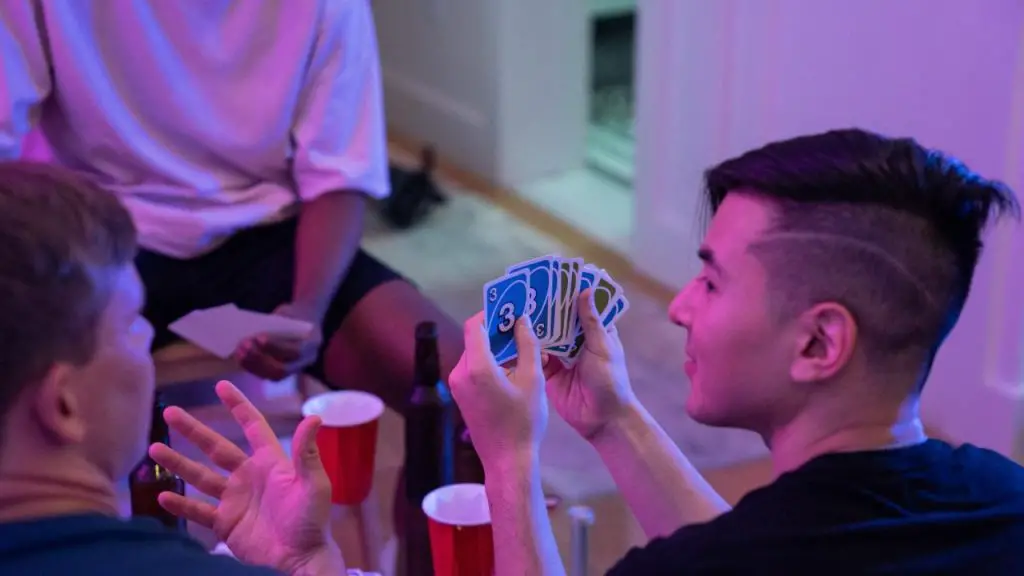 Friends Socializing Playing Drunk UNO. 