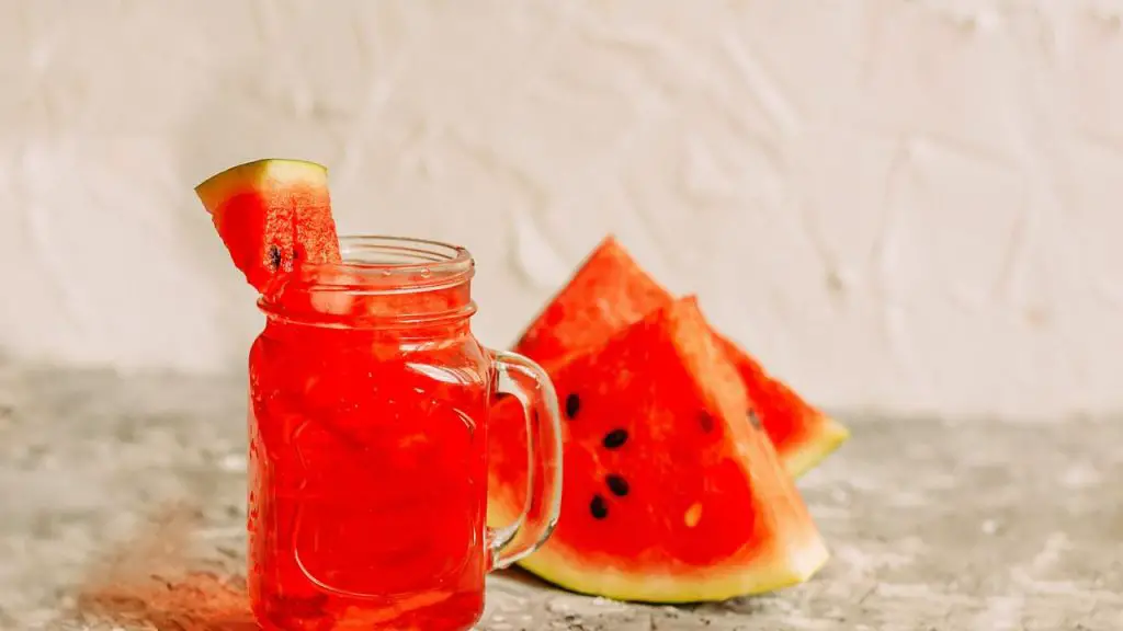 Watermelon Drink In A Mason Jar With Watermelon Wedges.